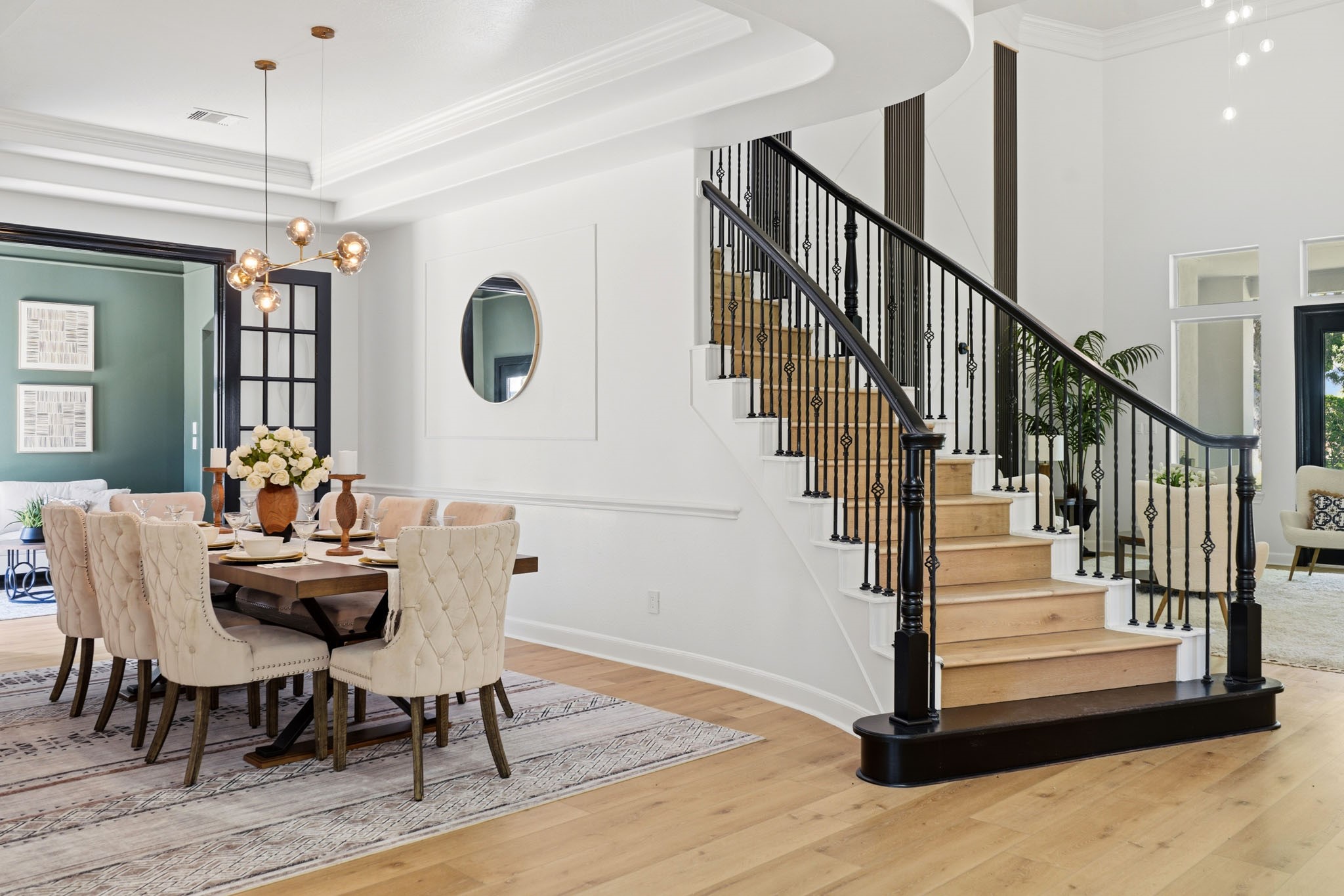 Impressive foyer and formal dining area filled with natural light and refined details.