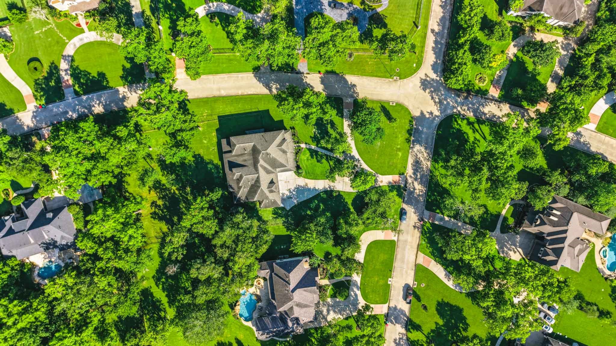 Breathtaking AERIAL VIEWS showcase this stunning custom estate nestled on 1.23 wooded acres in the front of Sienna.