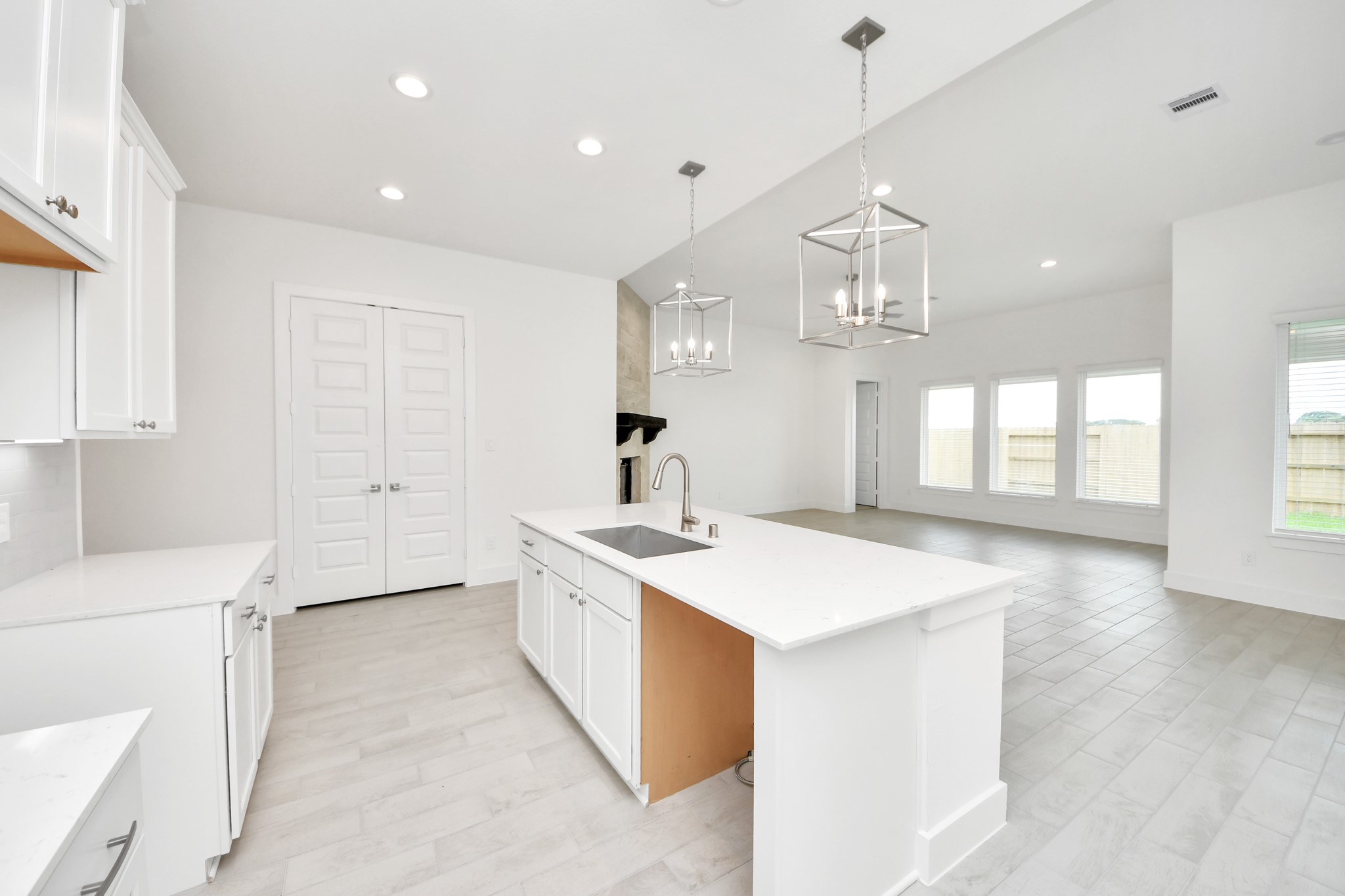 All of this overlooks your expansive family room, creating a perfect space for culinary delights and family gatherings. Sample photo of completed home with similar floor plan. Actual colors and selections may vary.