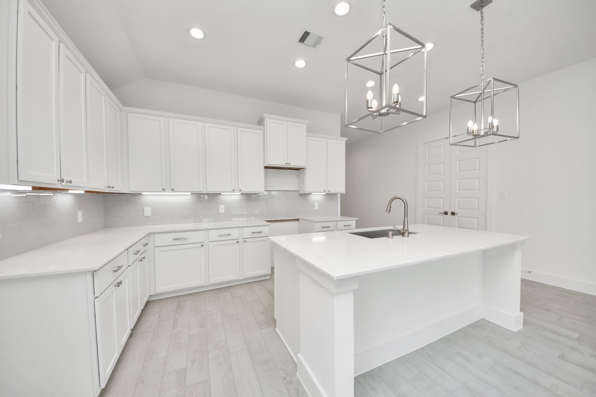 This kitchen is by far any chefs dream! This spacious kitchen features high ceilings, light stained wood cabinets, granite countertop, SS appliances, modern tile backsplash, recessed lighting, extended counter space, granite kitchen island, and space for breakfast bar, and a walk-in pantry all overlooking your huge family room. Sample photo of completed home with similar floor plan. Actual colors and selections may vary.