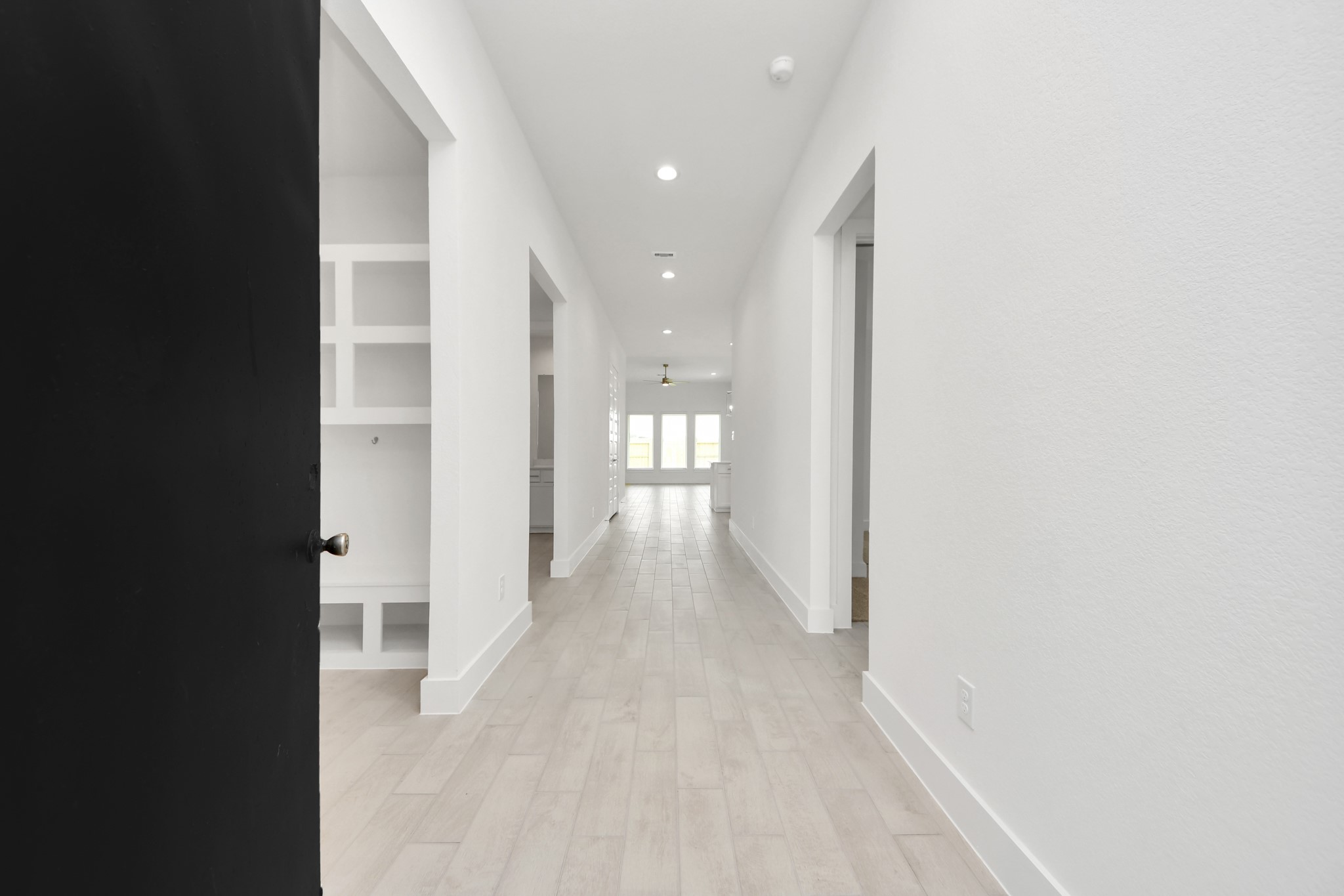 As you step into the threshold of this luxurious home, you'll soon be welcomed by an elegant glass door (to be installed). Inside, soaring ceilings amplify the spaciousness, while the refined wood-look tile flooring and oversized baseboards exude sophistication and charm. Sample photo of completed home with similar floor plan. Actual colors and selections may vary.