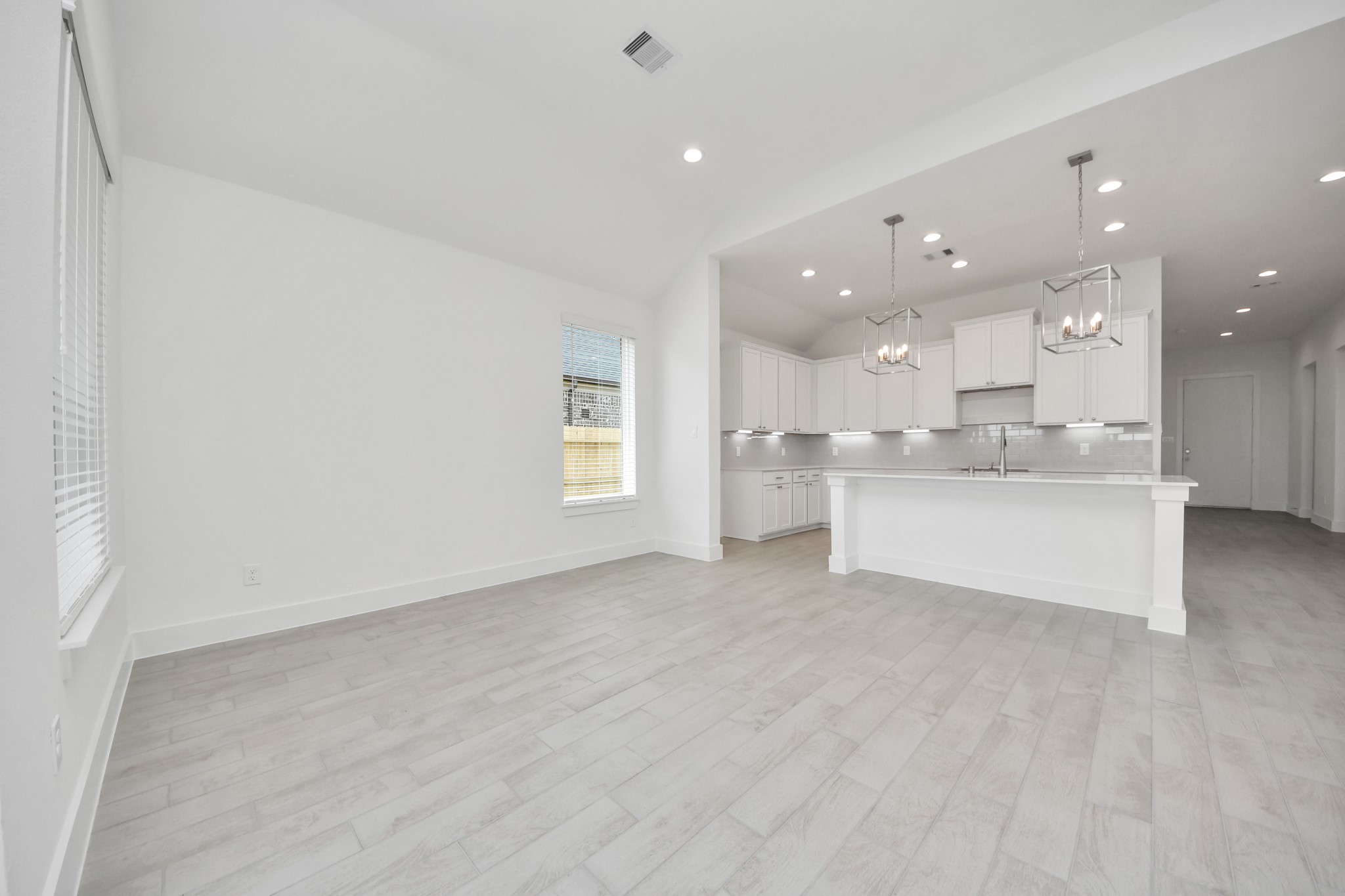 Discover another perspective of this stunning kitchen, generously appointed with an abundance of counter space. Sample photo of completed home with similar floor plan. Actual colors and selections may vary.