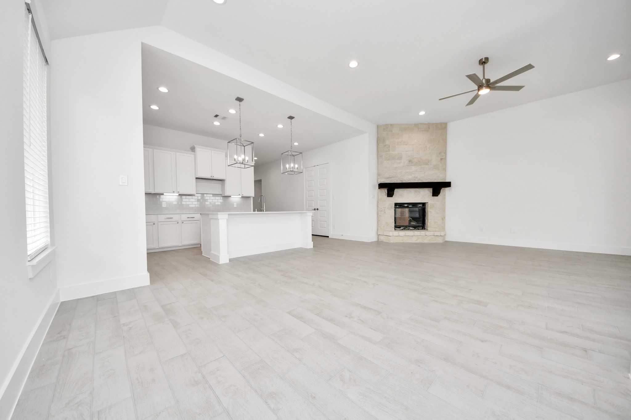 Gather the family and guests together in your lovely living room! Featuring soaring high ceilings, recessed lighting, ceiling fan, custom paint, gorgeous floors, and large windows that provide plenty of natural lighting throughout the day. Sample photo of completed home with similar floor plan. Actual colors and selections may vary.
