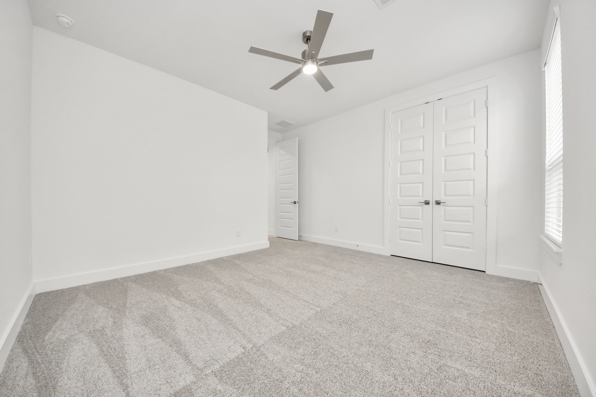 Generously sized secondary bedrooms featuring spacious closets, soft and inviting carpeting underfoot, large windows allowing plenty of natural light, and the added touch of privacy blinds for your personal retreat. Sample photo of completed home with similar floor plan. Actual colors and selections may vary.
