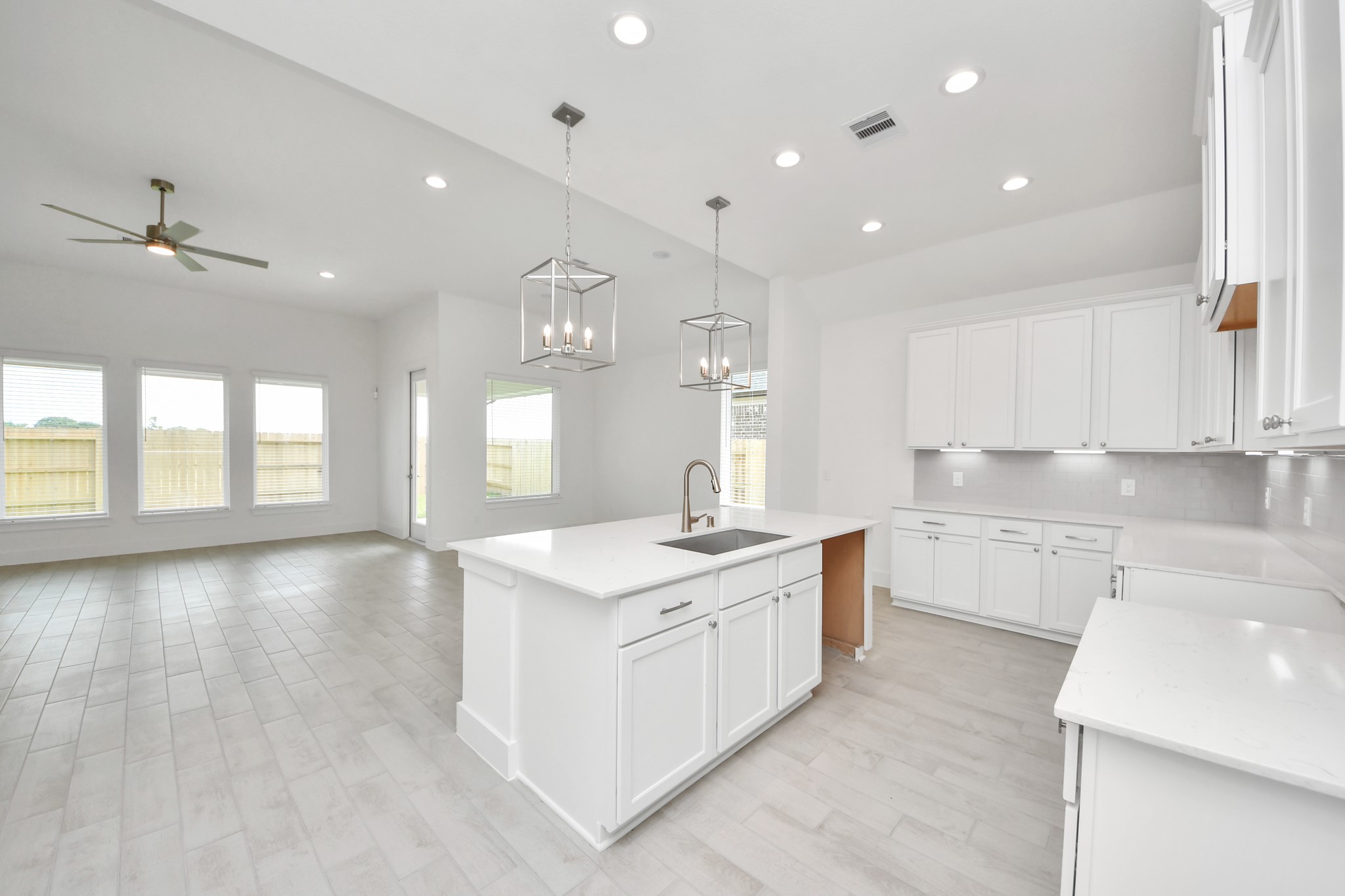 The kitchen is a culinary haven, featuring granite countertops, a tile backsplash, stainless steel appliances, 42 upper cabinets, and undercabinet lighting. Sample photo of completed home with similar floor plan. Actual colors and selections may vary.
