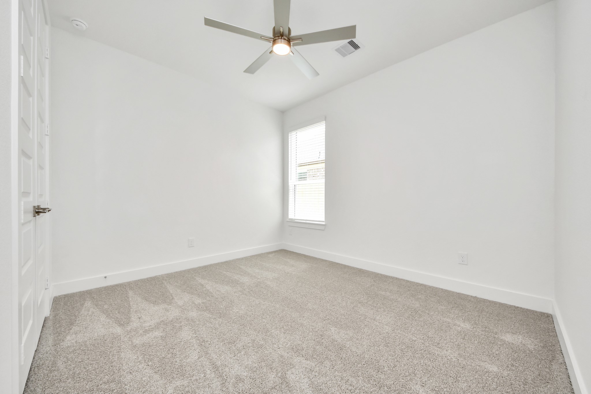 Secondary bedroom features plush carpeting, large windows that let in plenty of natural light, bright paint, and spacious closets. Sample photo of completed home with similar floor plan. Actual colors and selections may vary.