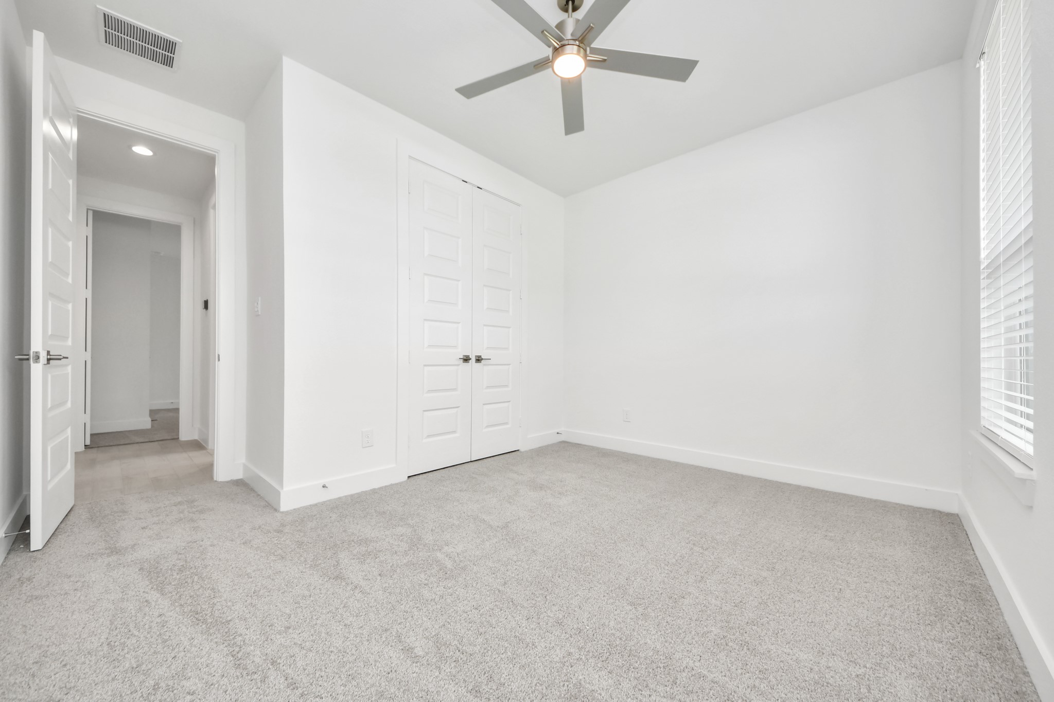 Generously sized secondary bedrooms featuring spacious closets, soft and inviting carpeting underfoot, large windows allowing plenty of natural light, and the added touch of privacy blinds for your personal retreat. Sample photo of completed home with similar floor plan. Actual colors and selections may vary.