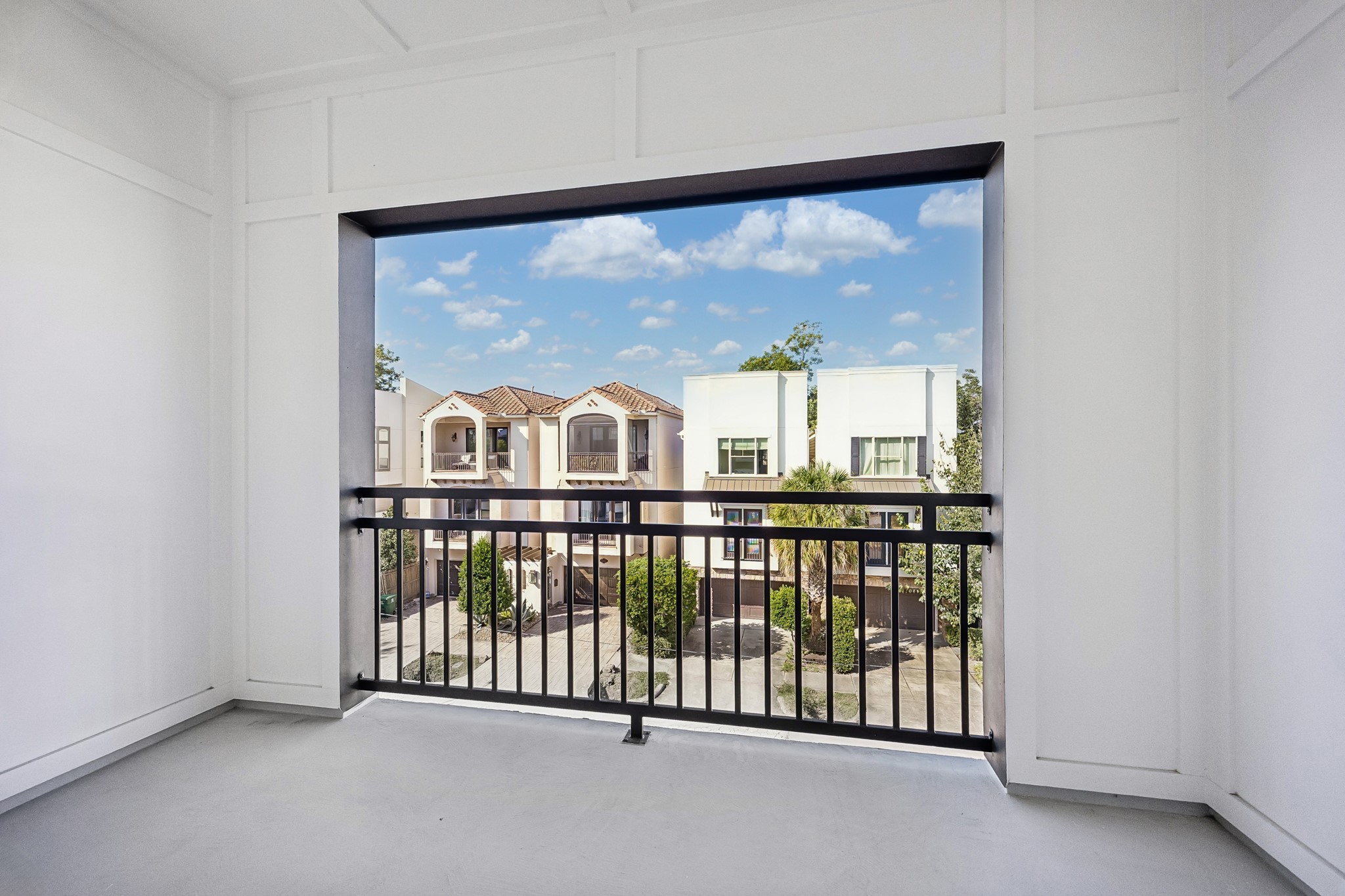 Covered balcony off of the game room with neighborhood views.