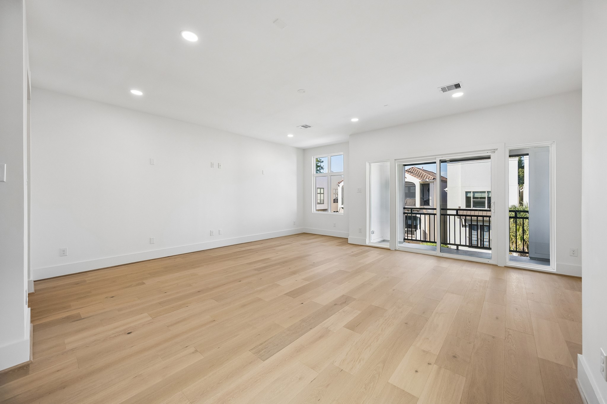 Game room  offers a spacious, versatile space with sliding glass doors to a private balcony.