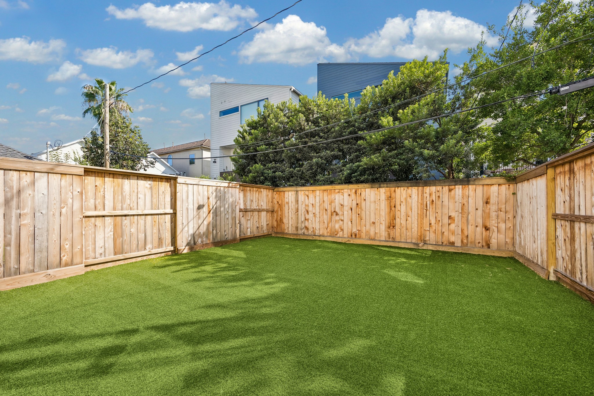 Another view of the expansive private backyard with low-maintenance turf.