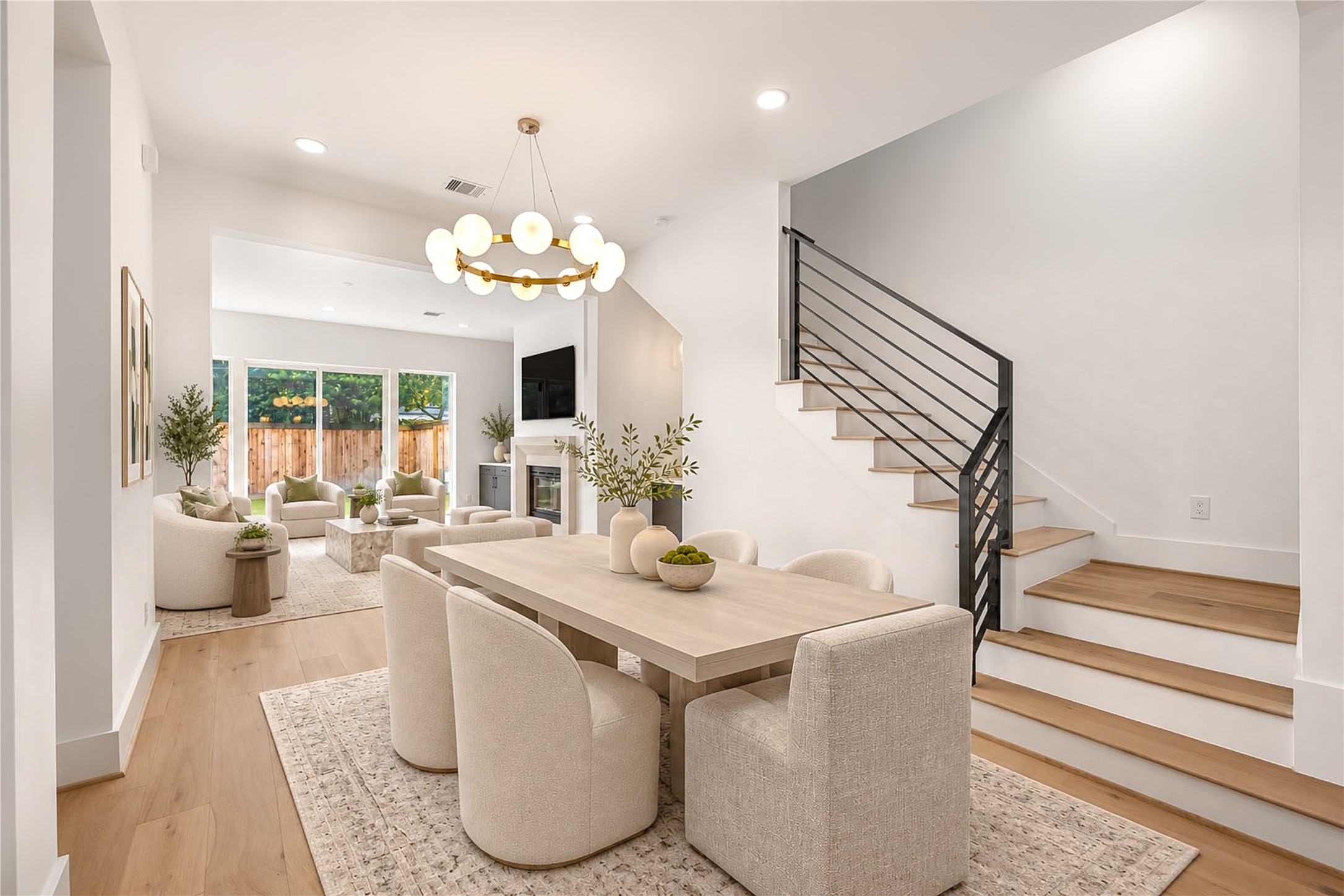 Another view of the dining area with the built-in dry bar and modern staircase.