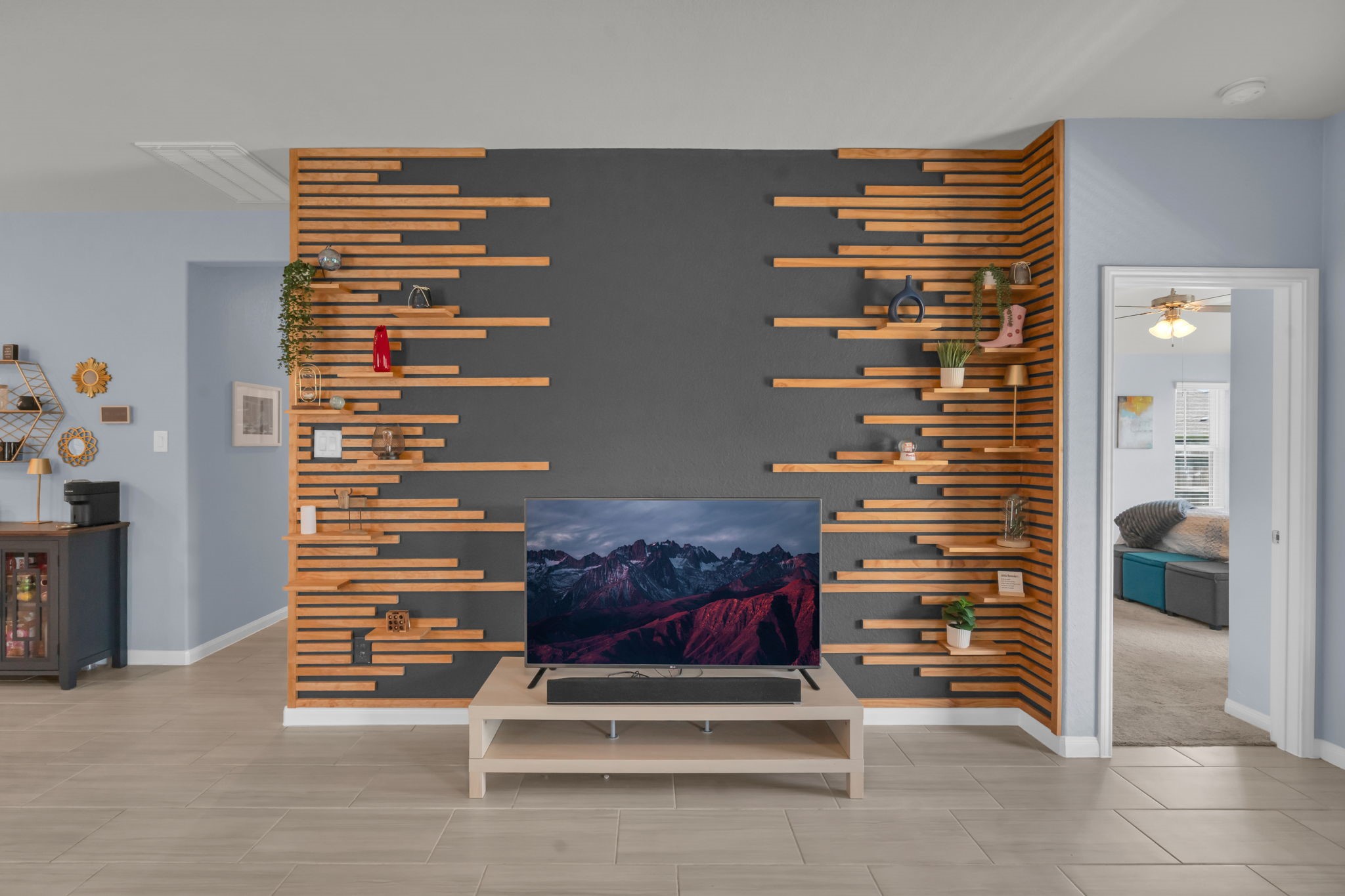 Closer look at the striking accent wall featuring built-in adjustable shelving for both style and functionality.