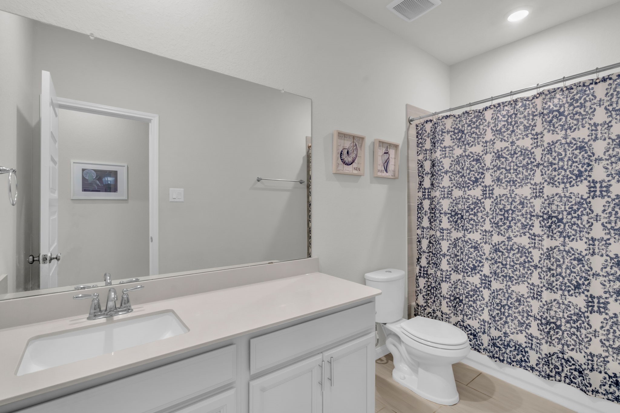 Secondary bathroom with lots of storage space and a combination tub and shower.