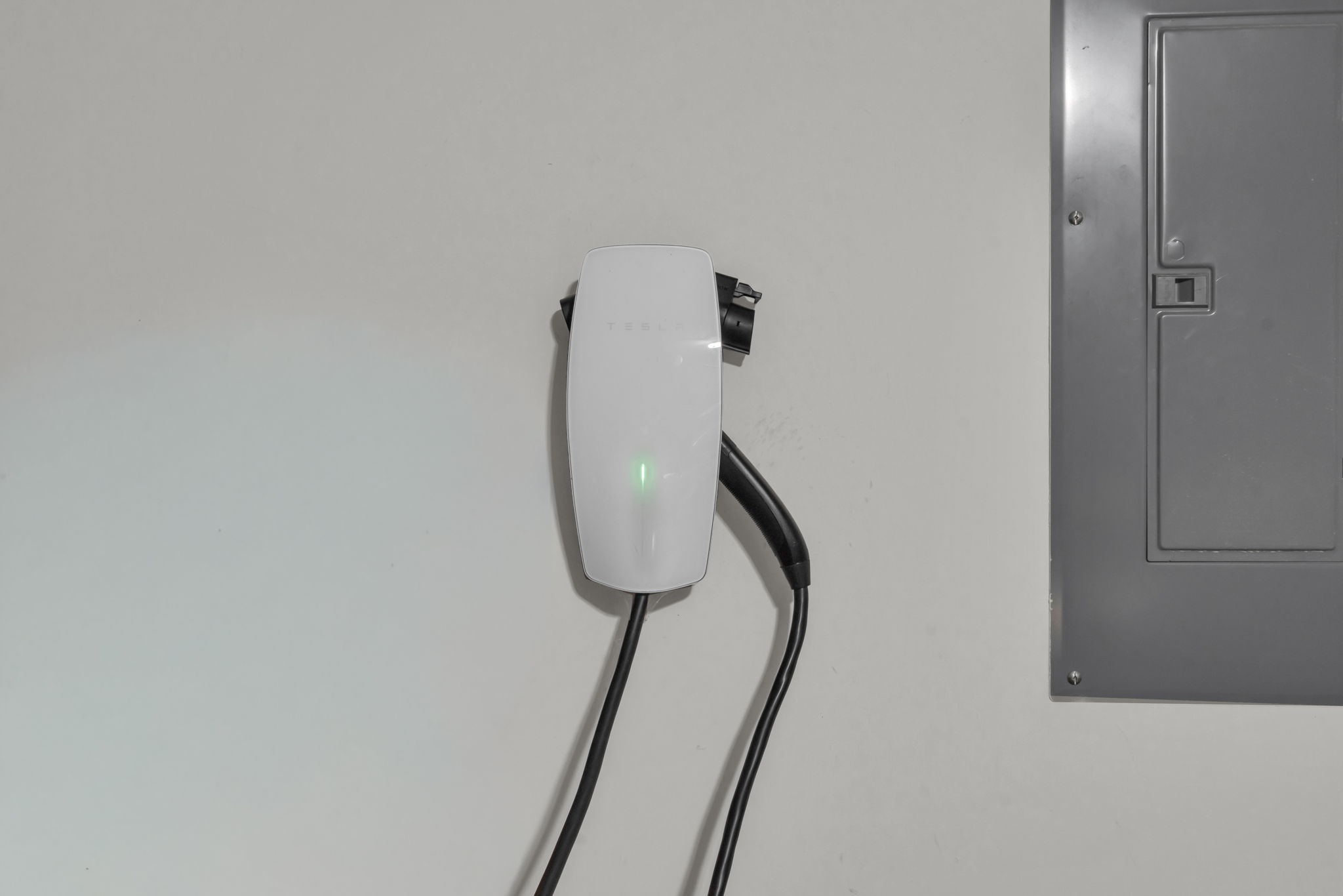 View of the Tesla EV charging station in the garage.