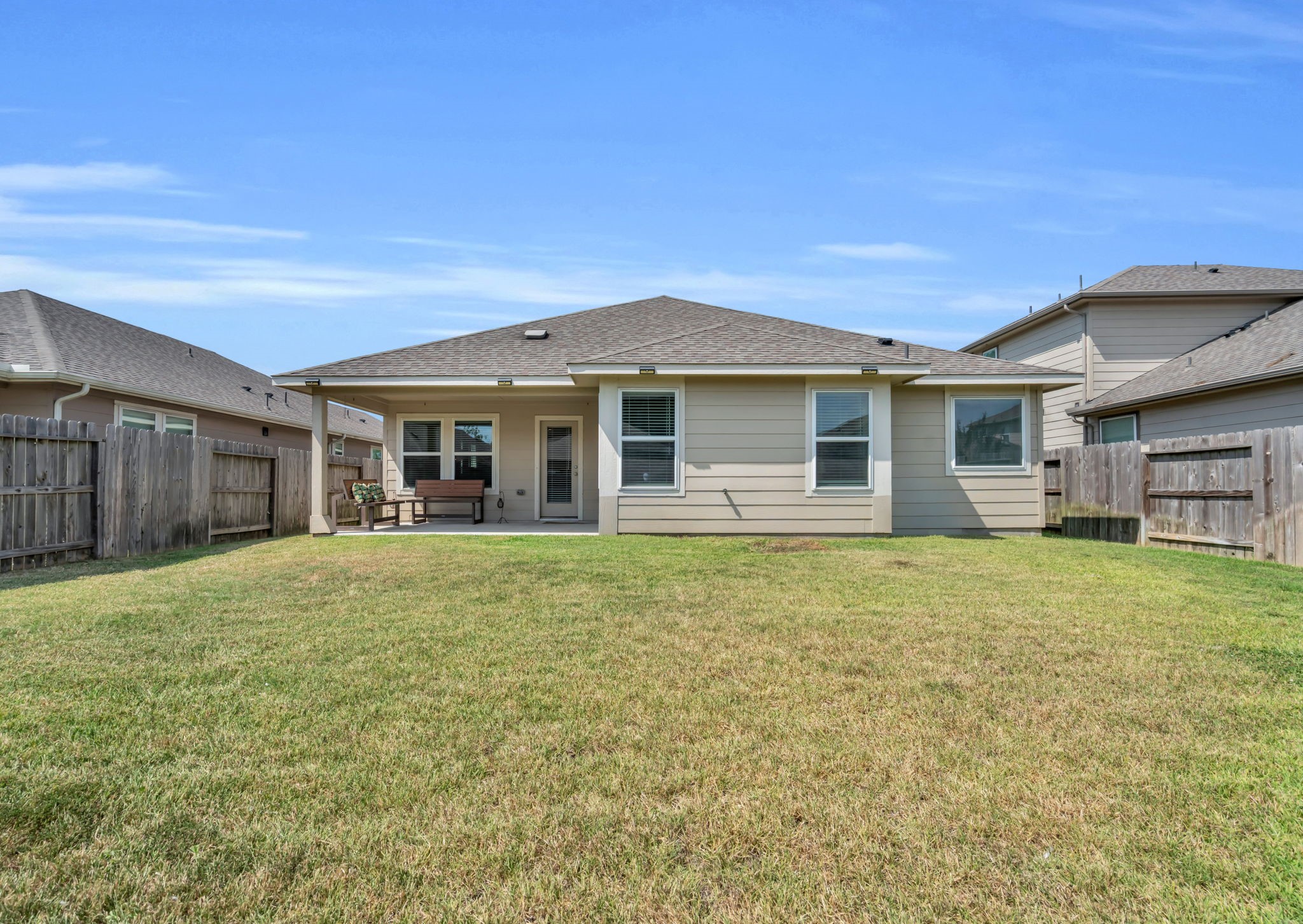 Full view of this backyard with tons of green space.