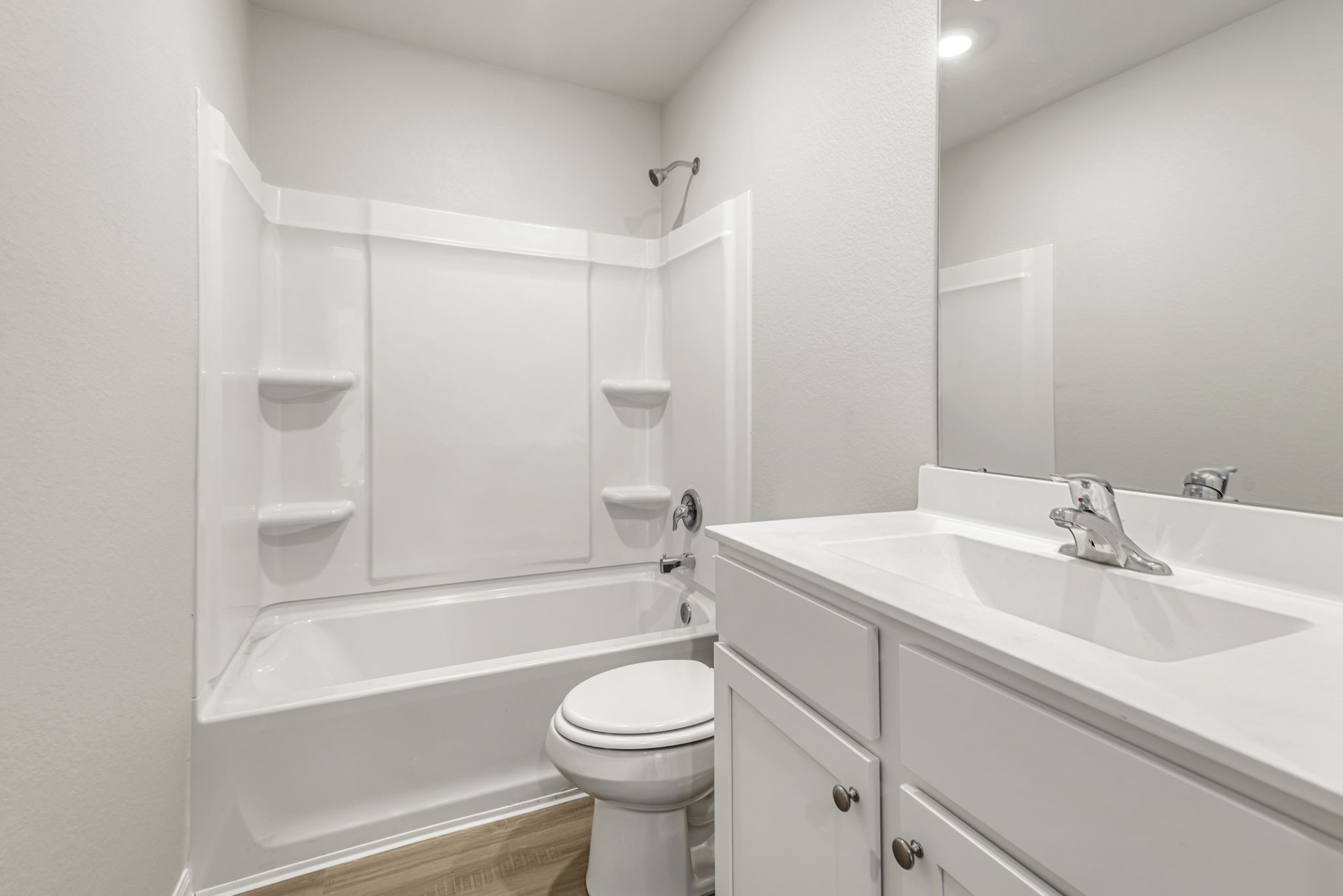 The secondary bathroom, located centrally in the hallway of the home.