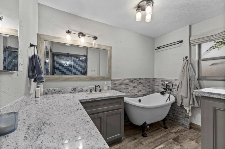 Main-house bathroom with generous vanity space and a freestanding bathtub.