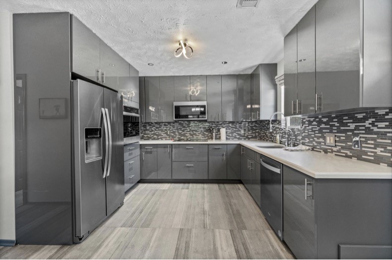 The separate guest suite features its own FULL kitchen with a refrigerator, cooking appliances, and ample cabinet storage.