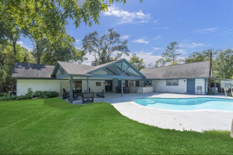 Private pool, covered patio, and outdoor kitchen create an inviting backyard retreat. Landlord provides pool maintenance.