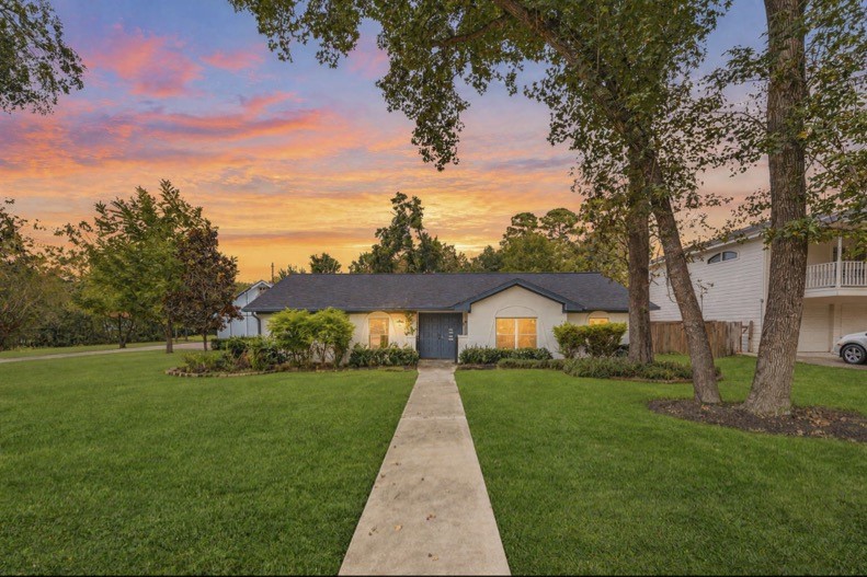 Twilight view of the home and its welcoming front entrance.