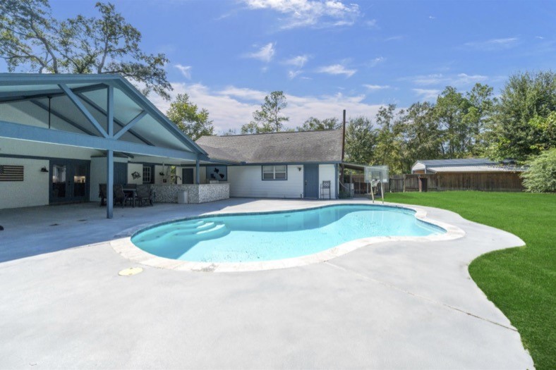Private gunite pool with a spacious surrounding deck and access to the covered patio.