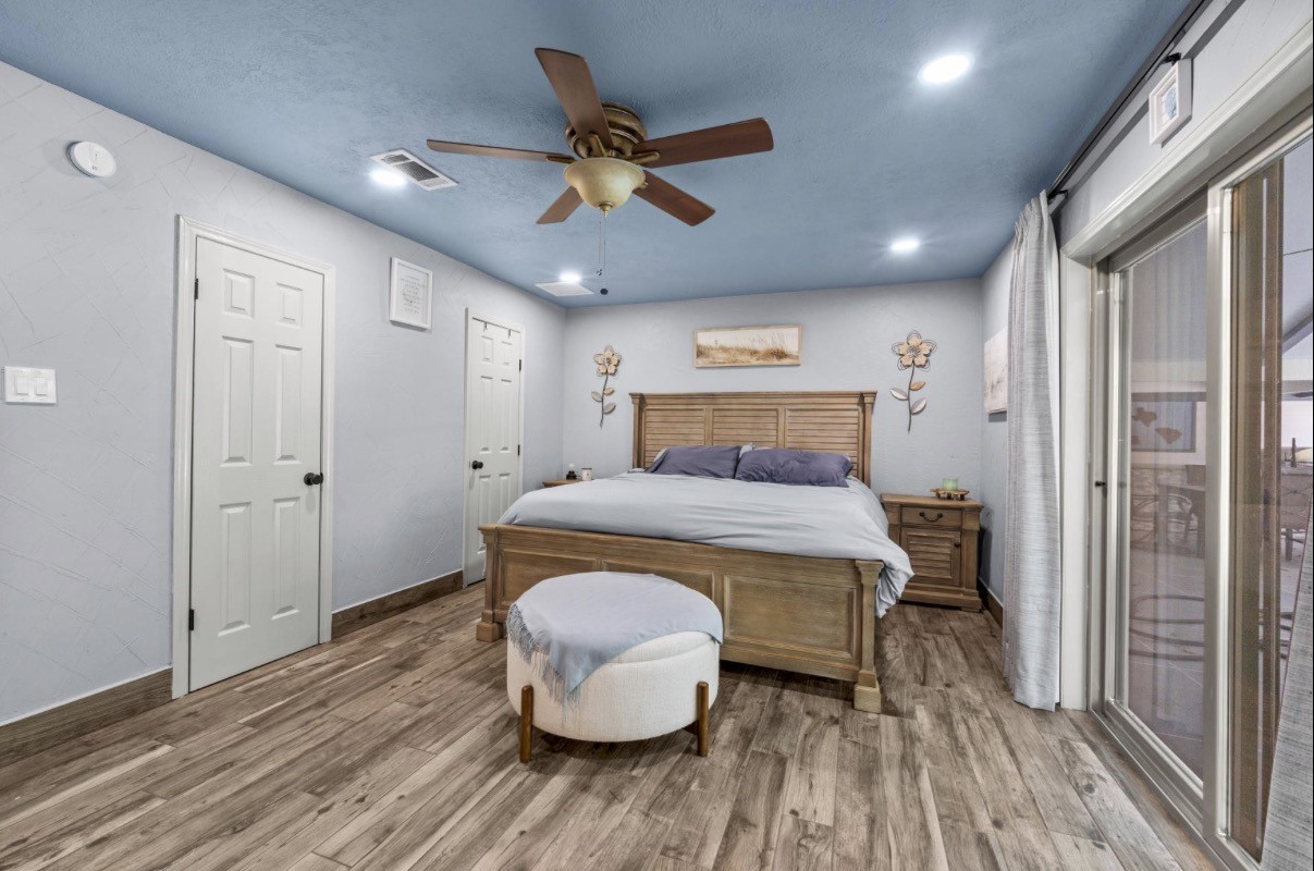 Another view of the spacious primary bedroom and its closet doors.