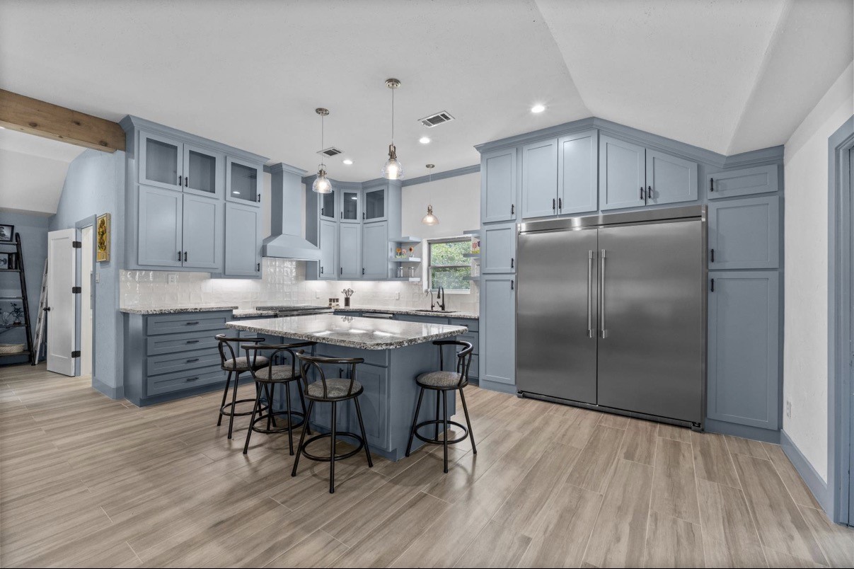 Large kitchen island offers seating and additional preparation space beneath pendant lights. All Appliances Included!!