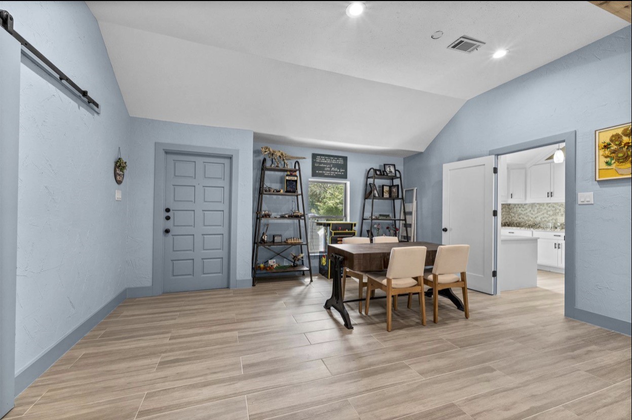 Spacious home office/study area with a vaulted ceiling and convenient access to the adjoining living spaces. This room can also be used as a 4th bedroom. Full closet attached.