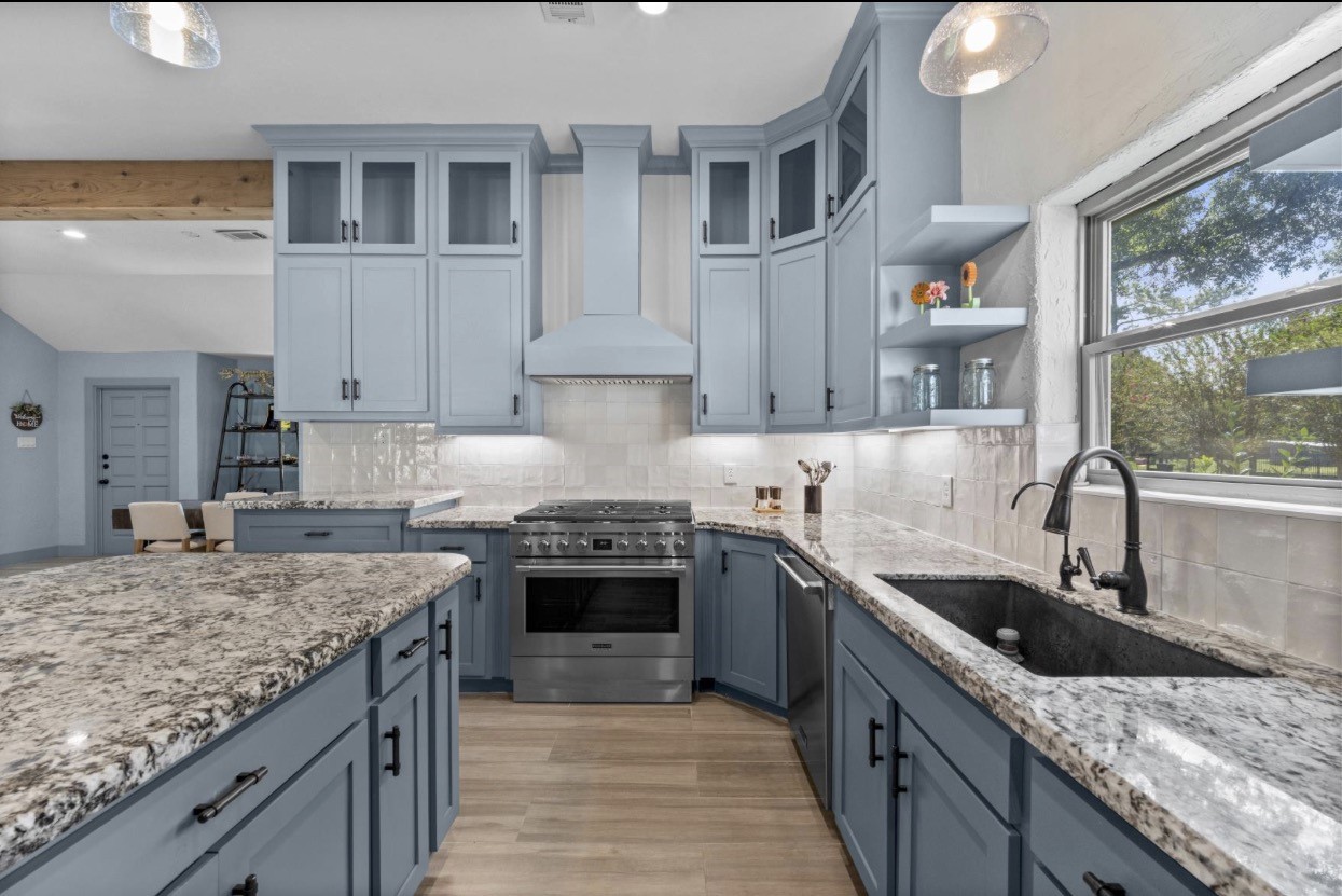 Main-house cooking area with a range, generous counter space, and a sink beneath the window.