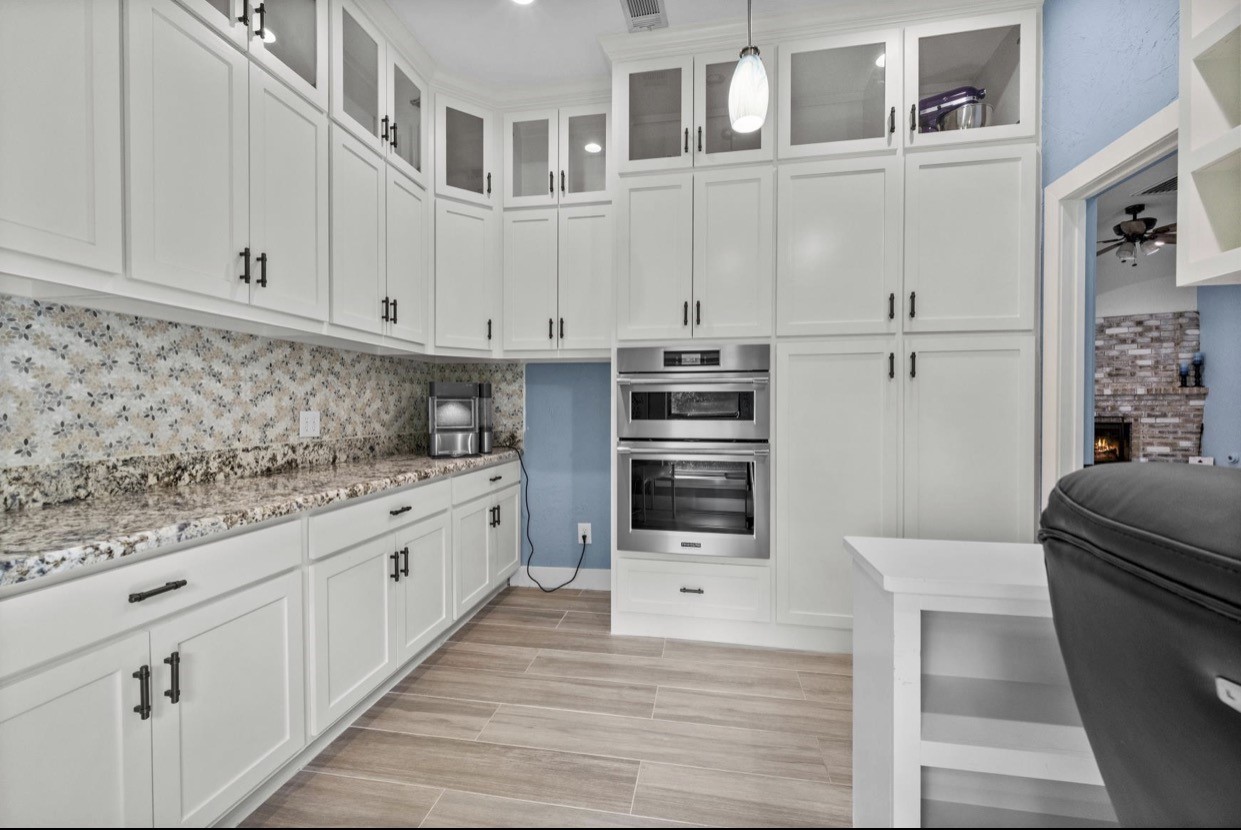 Additional cabinetry and built-in appliances provide convenient storage and preparation space.