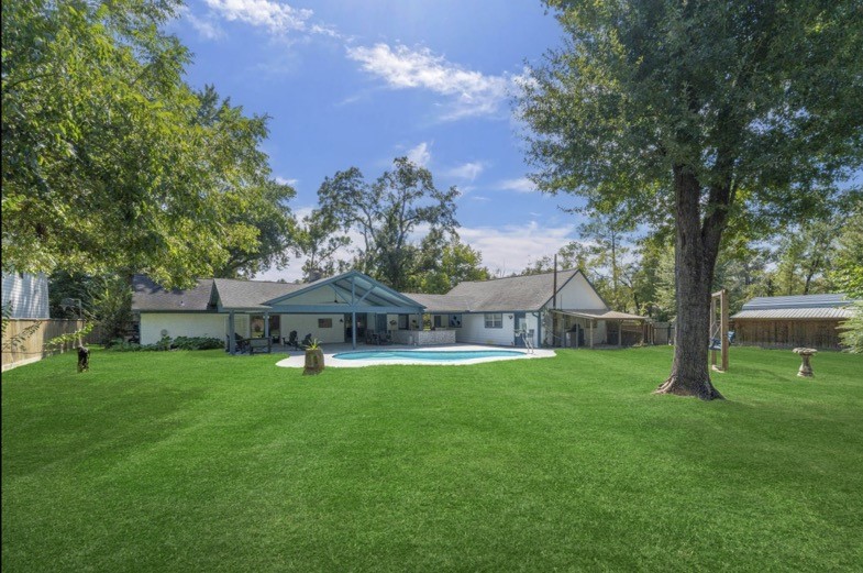 Expansive lawn and mature trees offer room to enjoy this lot of more than half an acre.