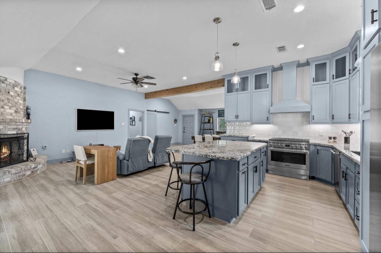 The island kitchen opens directly to the living room for easy everyday gathering.