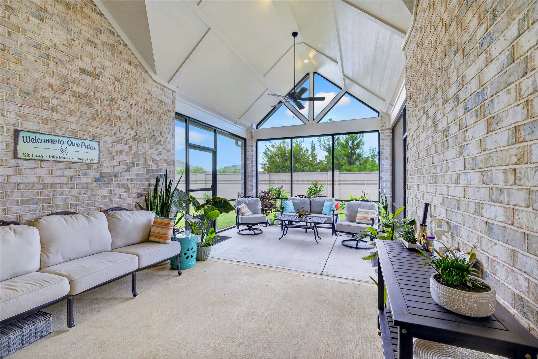Styled and ready to enjoy this screened porch feels like an extension of the home itself. Comfortable furnishing and lush greenery create a warm, inviting space to relax, host friends, or curl up with a good book, all while enjoying the beauty of the outdoors without ever leaving the comfort of shade and screen.