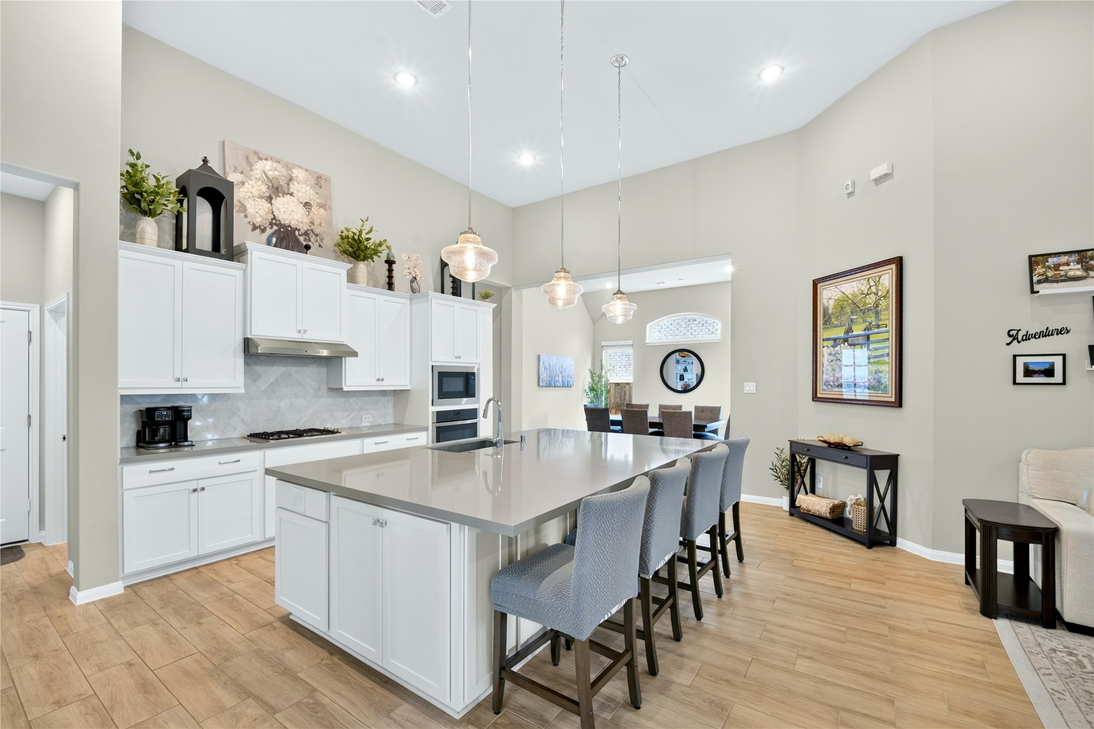 The large island with seating for four bar stools, easy-maintenance tile flooring, perfect for casual dining or entertaining.