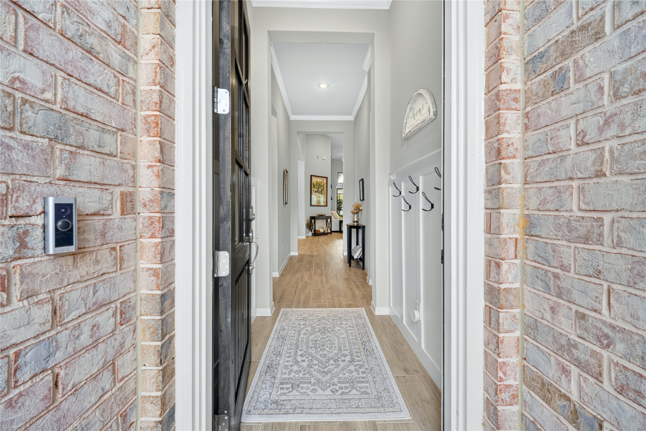 Welcoming entryway foyer featuring high ceilings and elegant tile flooring.