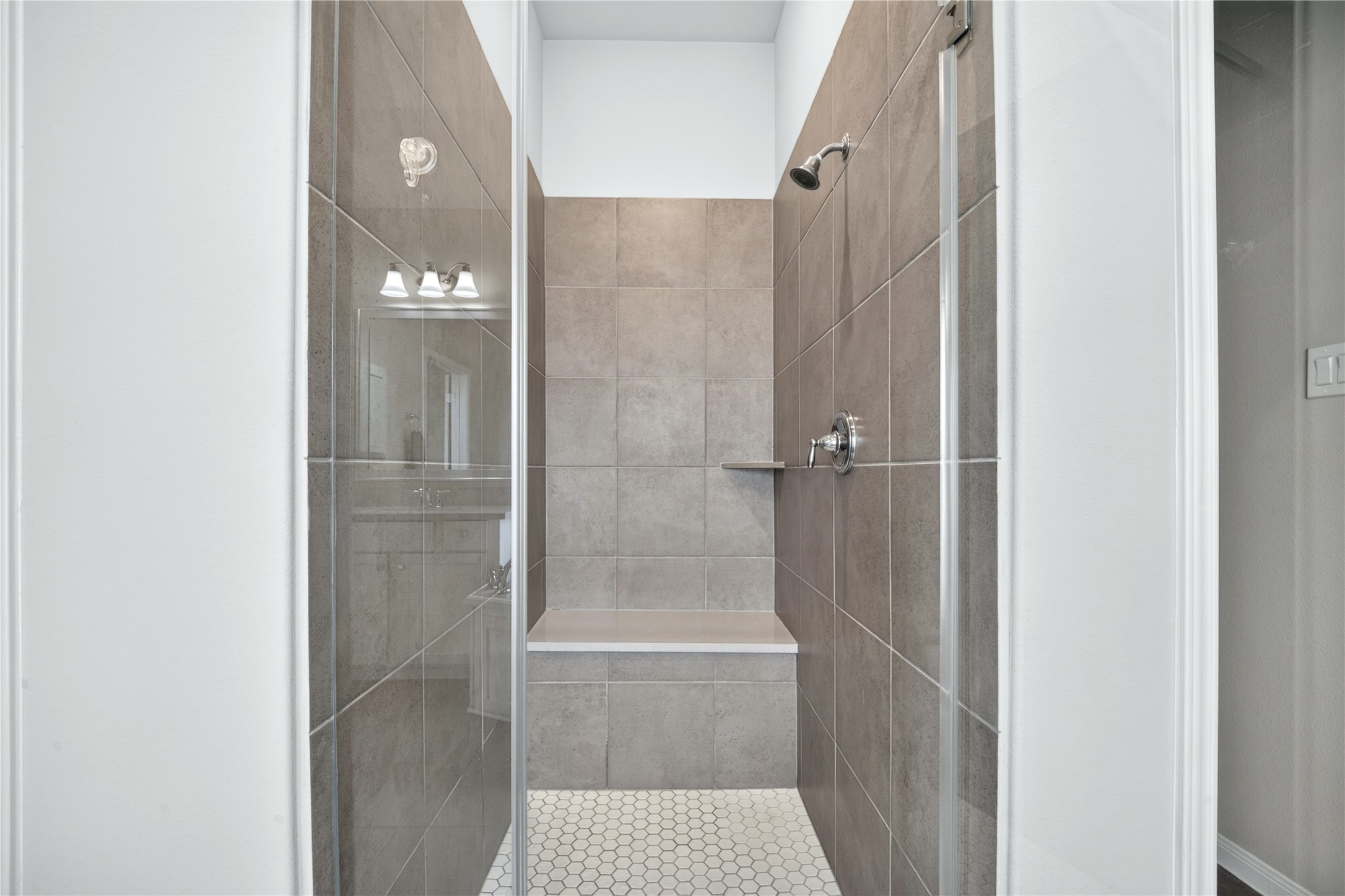 Elegant and spacious, the large walk-in shower creates a beautiful focal point in the primary bathroom.