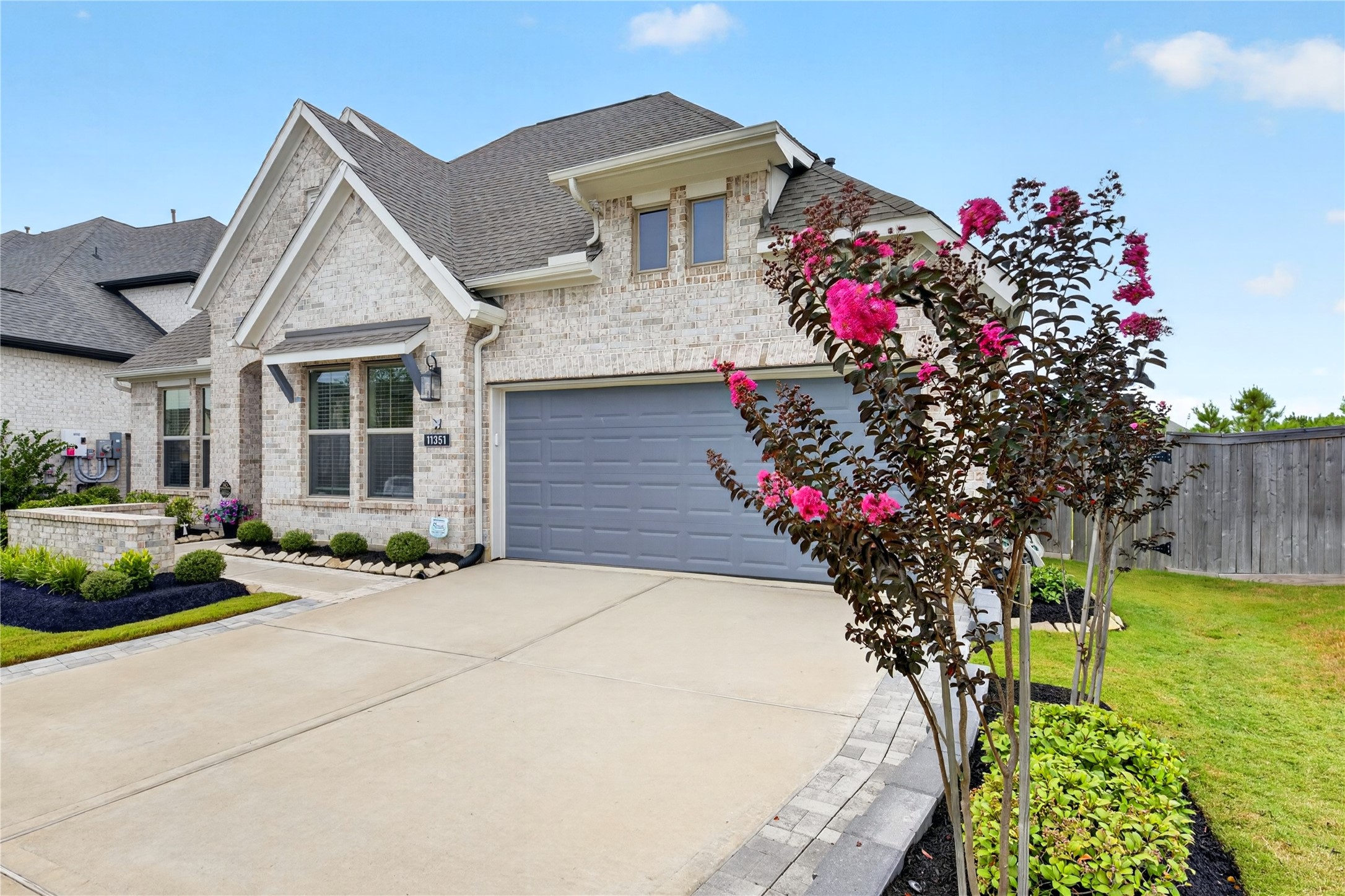 Beautifully landscaped grounds and expanded driveway, gutters and a front and back sprinkler system.