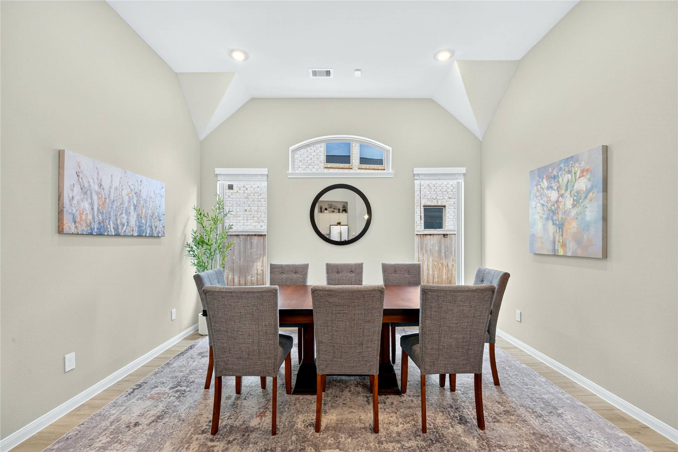 The dining room features beautiful windows that fill the space with natural light.