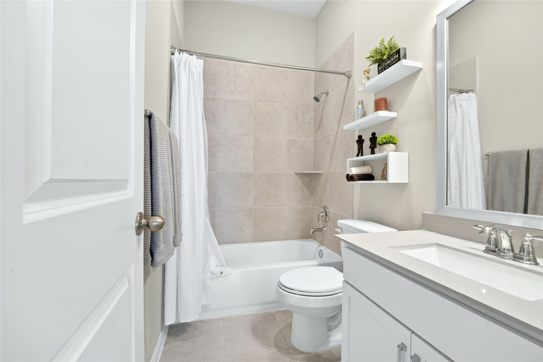 The full bathroom is thoughtfully positioned next to one of the secondary bedrooms a the front of the home.