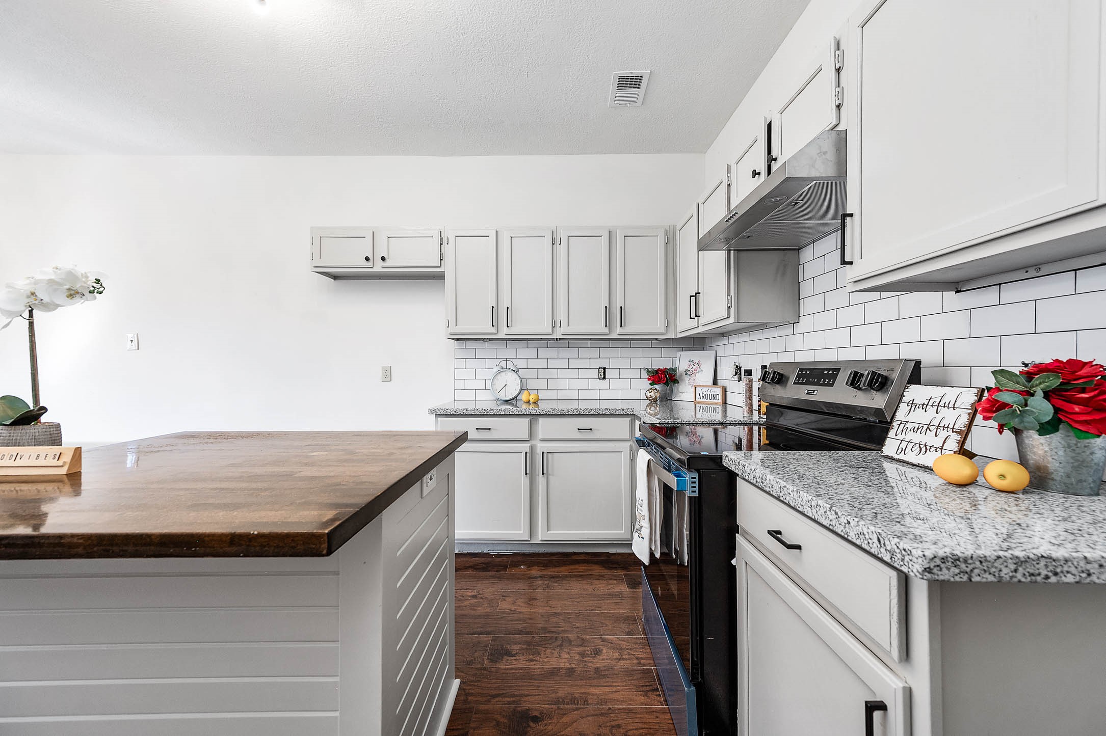Remodeled kitchen with Butcher Block island, new SS applianced and granite counter top