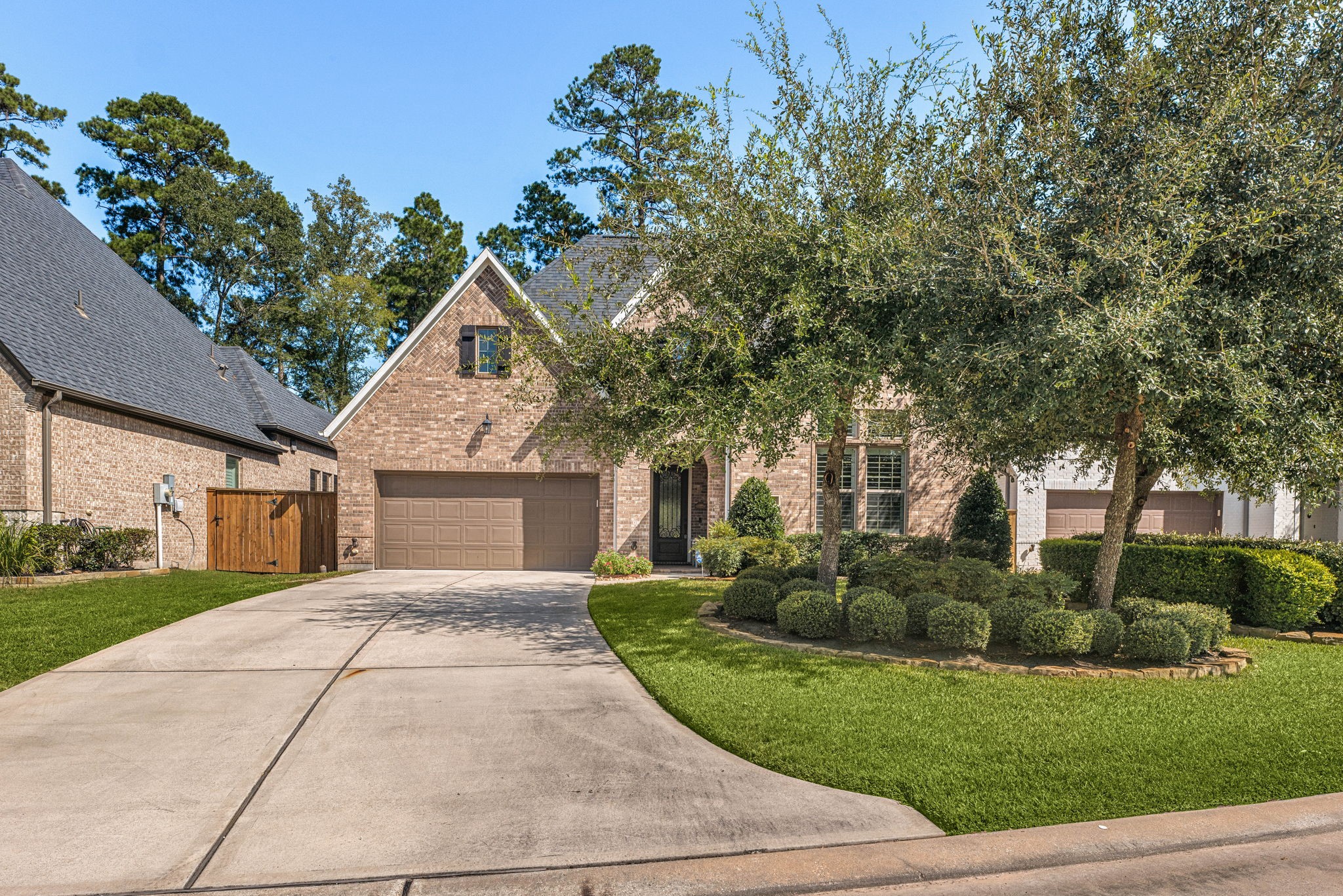 Beautiful curb appeal from every angle! Mature shade trees, manicured landscaping, a lush green lawn, and a spacious driveway welcome you home!
