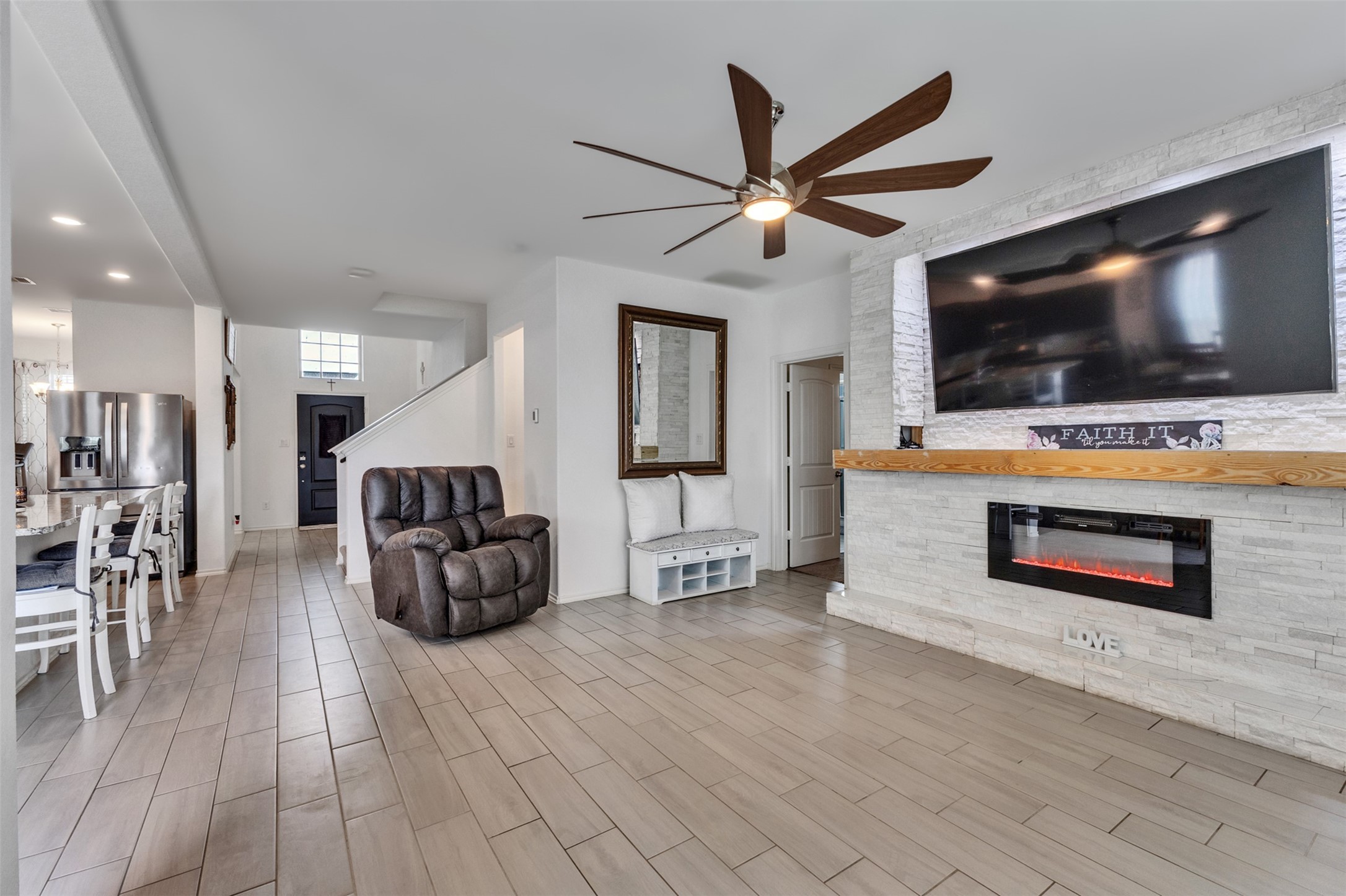 This 82-inch Tv stays!!! The remote-control fireplace features color changing flames. You may also select heat ofr just ambient flames.