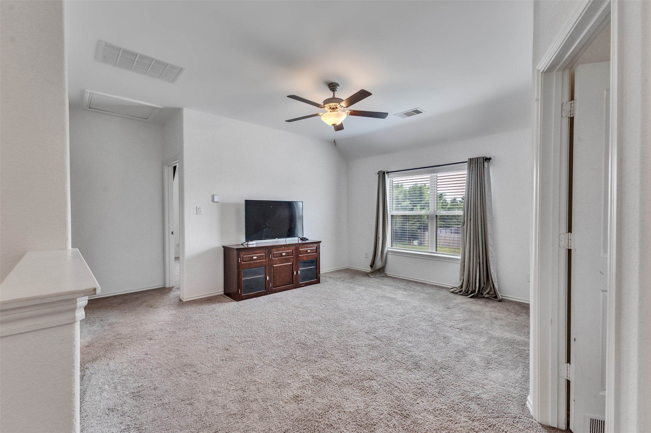 This spacious primary bedroom allows for a king size bed plus room for more!