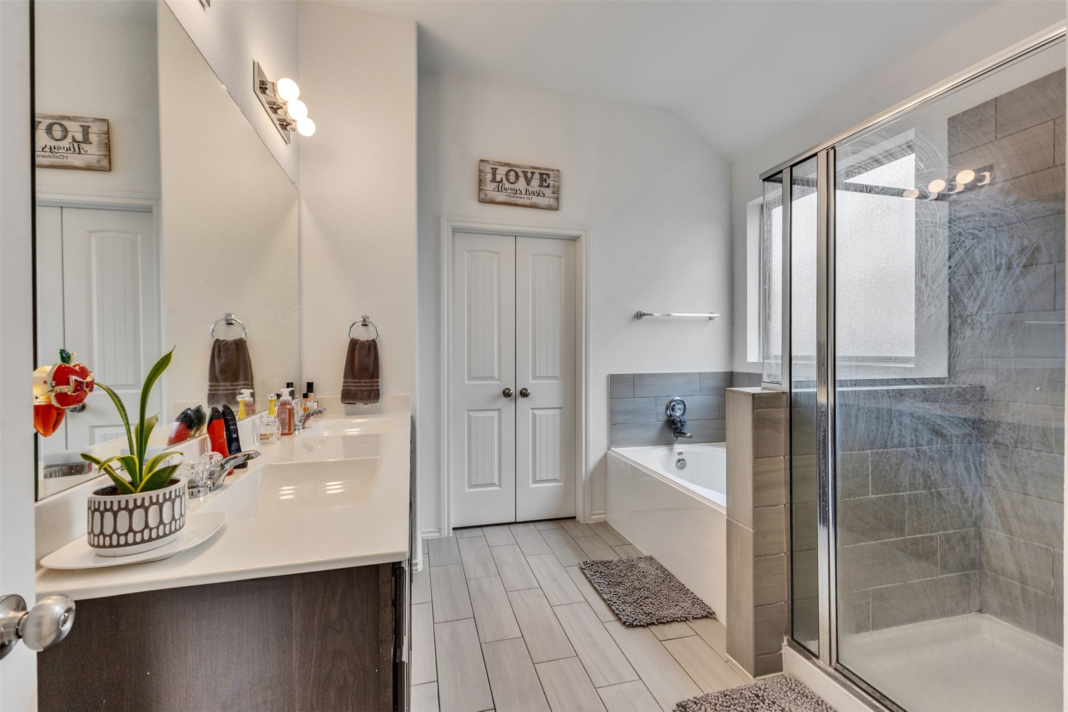 This serene spa like primary bath features soft neutral tones. A soaking tub, separate shower and dual sinks offers an ambient atmosphere to prepare for the day!