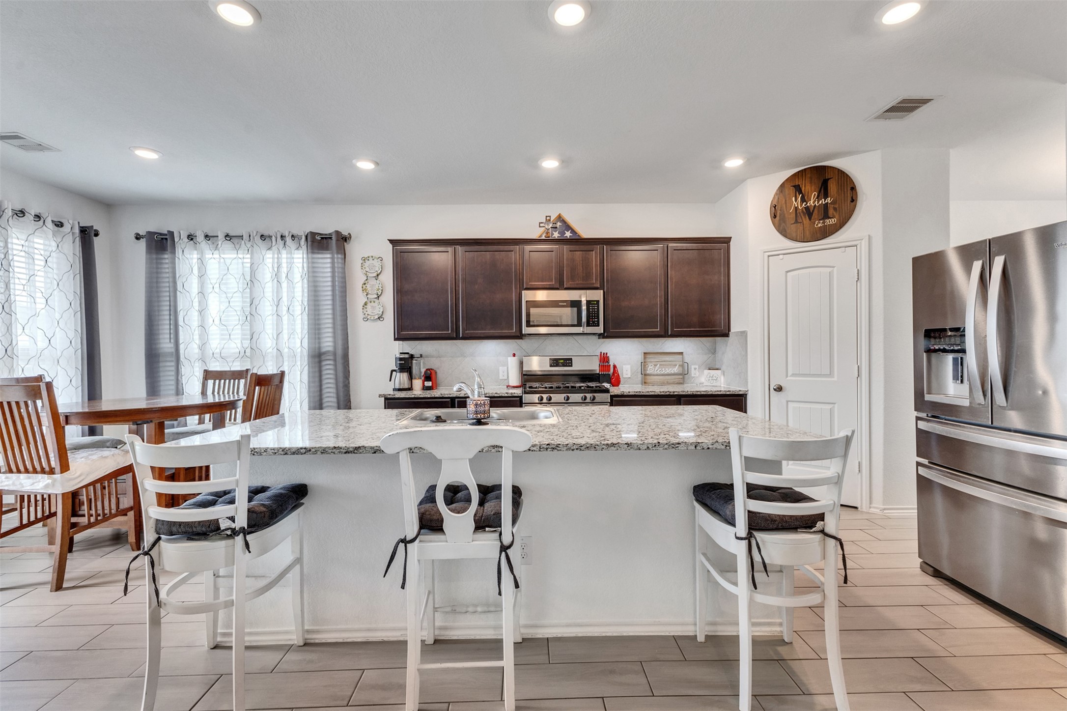 This bright and airy kitchen flows seamlessly into the open family room.