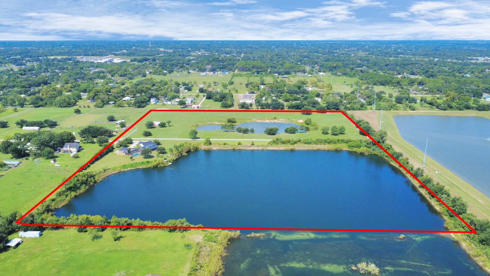 Both properties. Property line in red is not the exact property boundary line, It is showing what the seller iis currently using including the R.O.W. Buyer to verify property boundary lines.