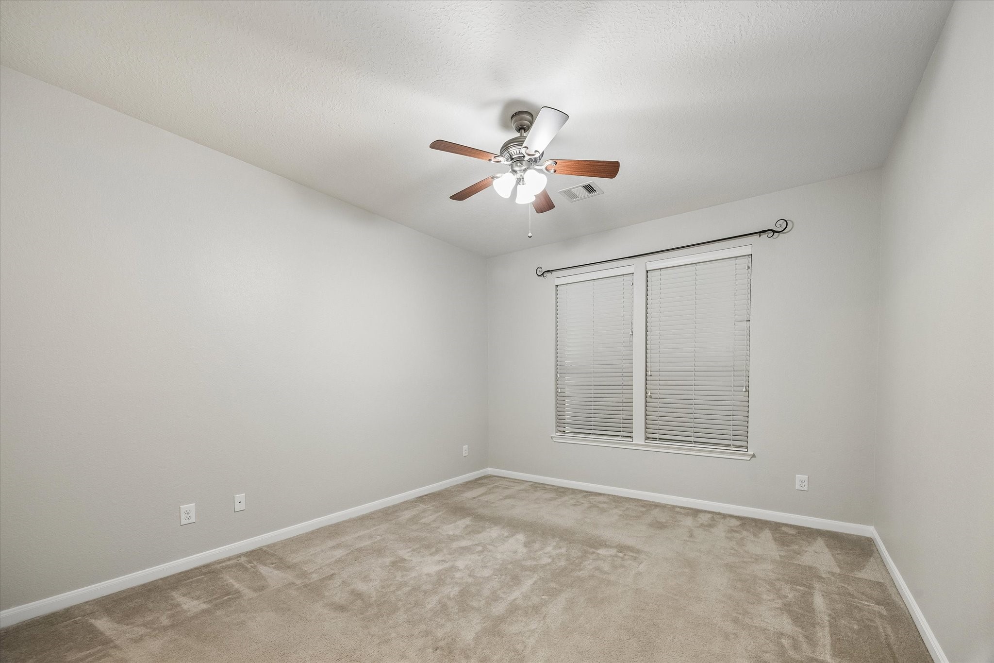 Privately situated primary suite at the rear of the home.