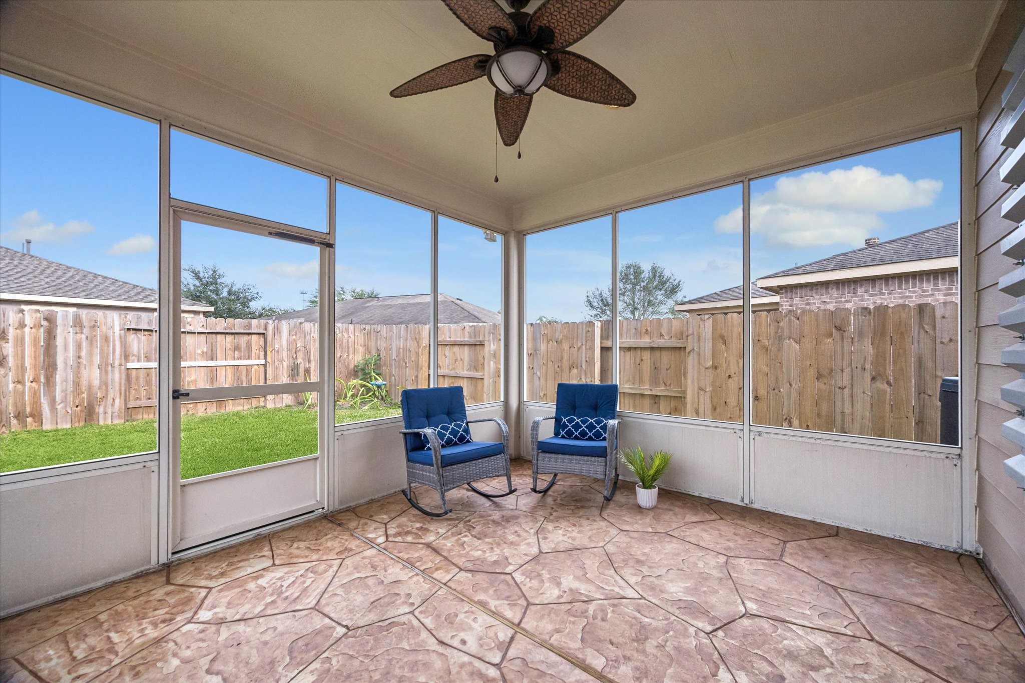 Screened-in patio offers a comfortable extension of the home's living space.