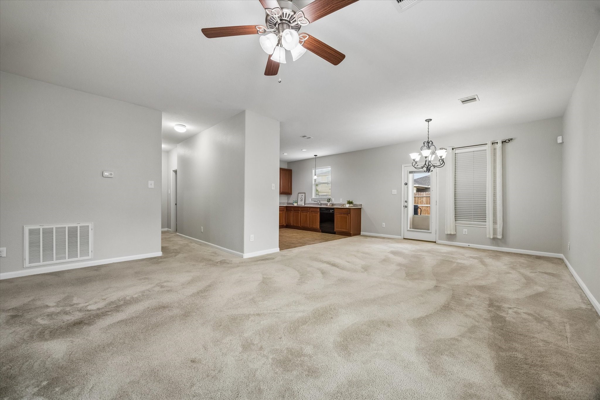 An inviting living room that flows seamlessly into the kitchen and dining area.