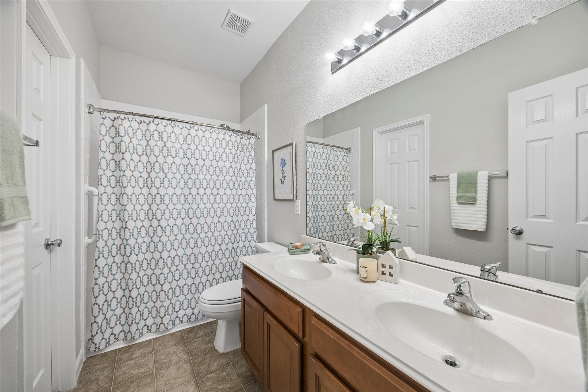 Primary ensuite bathroom with a generous walk-in closet.